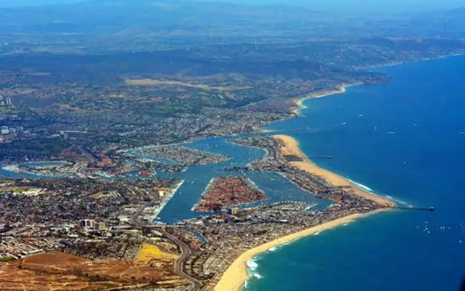 Aerial view of Newport Harbor and the Balboa Peninsula coastline in Newport Beach, CA